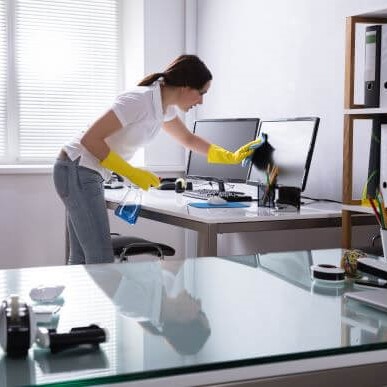Sanitation Professional Wiping Down Office Desk Sanitation Professional Wiping Down Office Desk