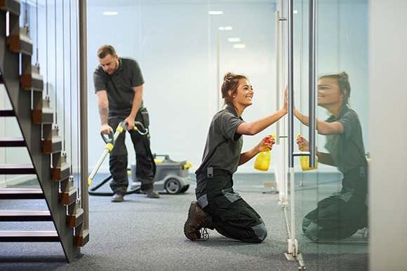 Uniformed janitorial workers cleaning and vacuuming. Uniformed janitorial workers cleaning and vacuuming.