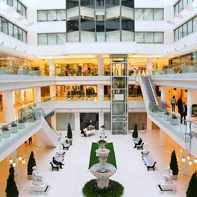 People walking around in large indoor mall serviced by CAM property services People walking around in large indoor mall serviced by CAM property services