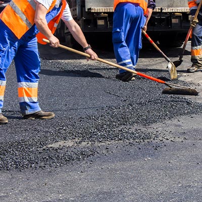 Workers Repairing Pavement Damage Workers Repairing Pavement Damage