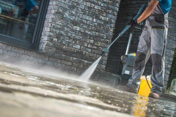 Power Wash Technician Cleaning Commercial Pavement Power Wash Technician Cleaning Commercial Pavement