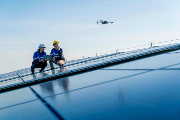 Solar Technicians Operating Overhead Drone Solar Technicians Operating Overhead Drone
